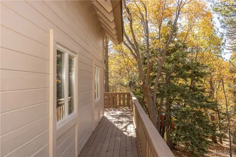 a view of a porch with wooden floor and fence