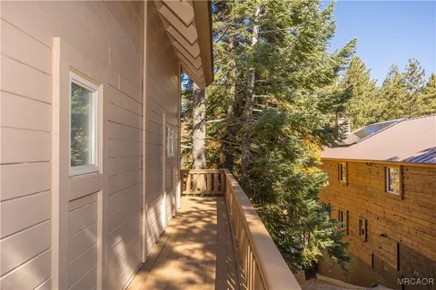 a view of a balcony with wooden fence and floor