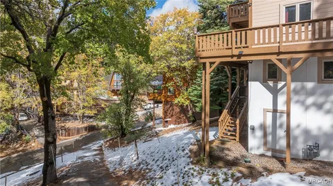 a view of a wooden house with a tree