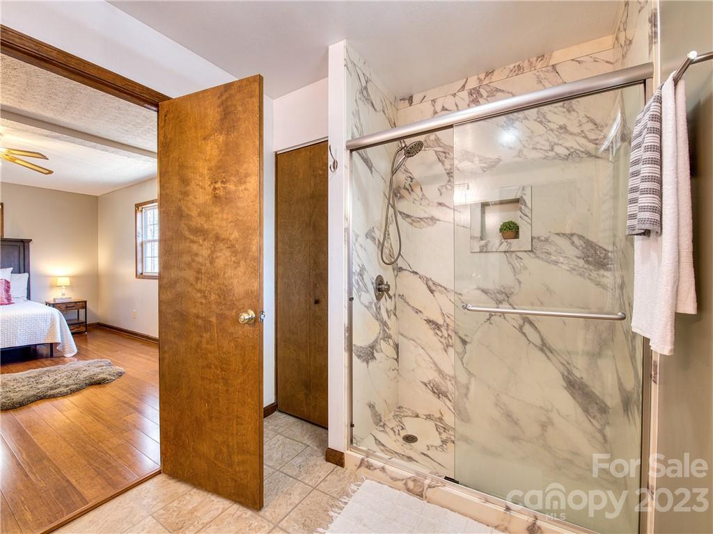 353 Rustic Heights Road Waynesville, NC 28785 - Photo 6 of 46 a bathroom with a shower and a sink