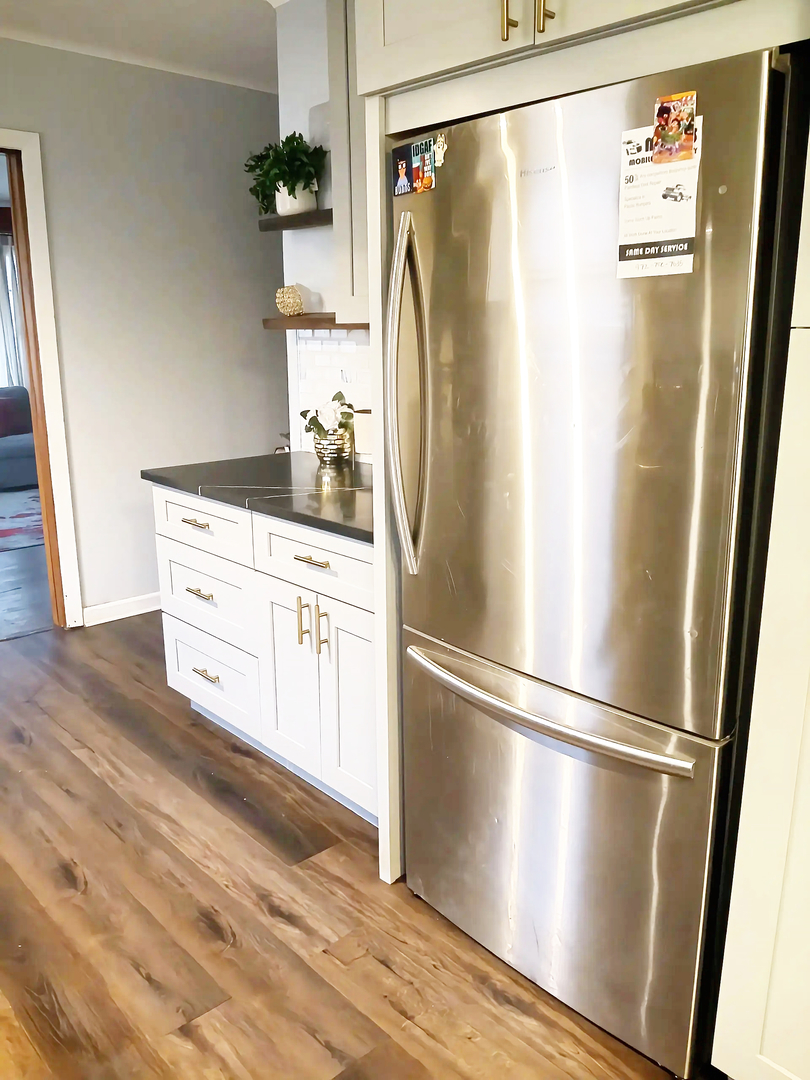 18404 Perth Avenue Homewood, IL 60430 - Photo 6 of 11 a kitchen with stainless steel appliances a refrigerator and a wooden floor