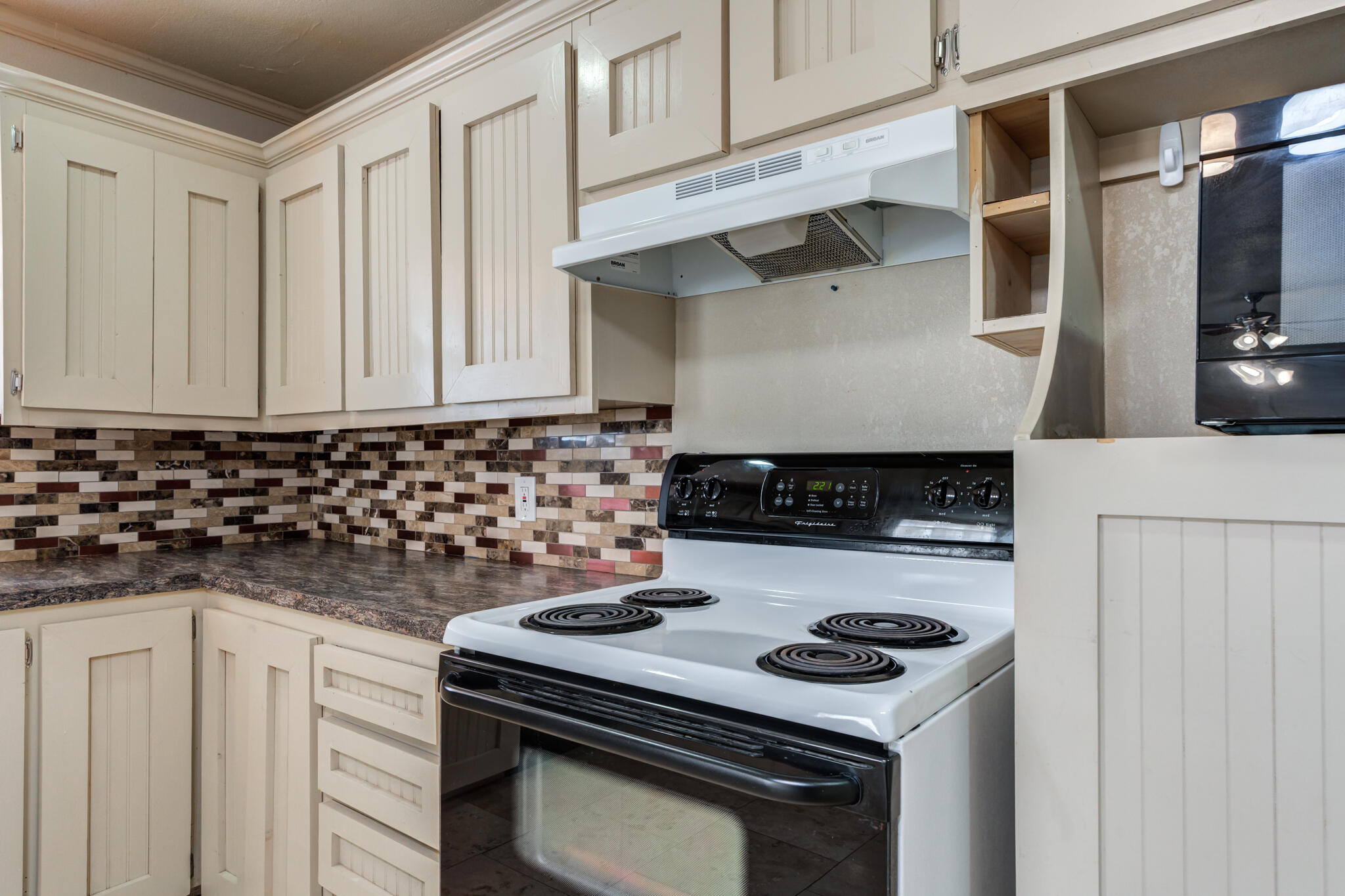 3517 47th Street Lubbock, TX 79413 - Photo 11 of 36 a kitchen with granite countertop a stove and a sink