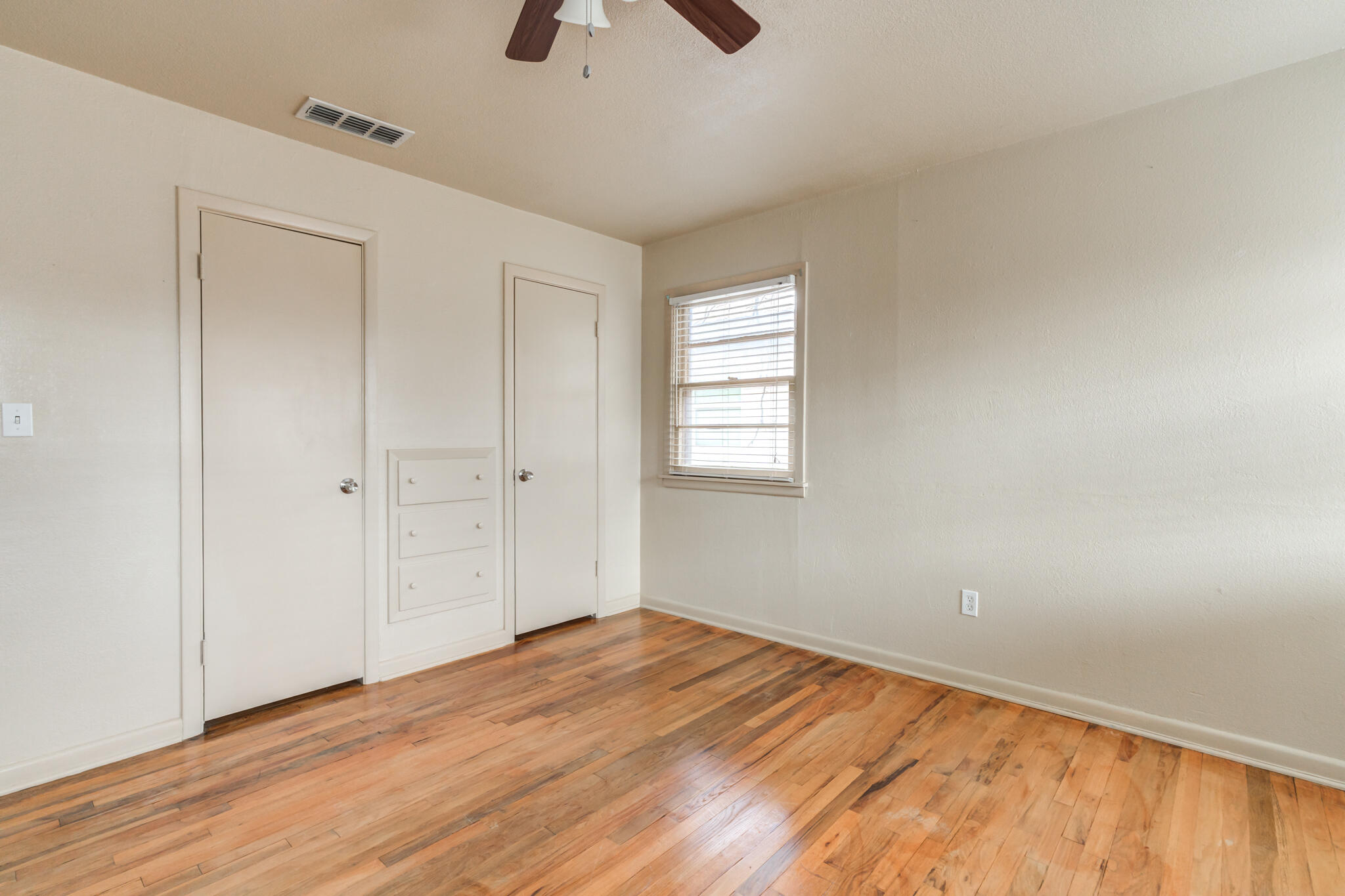 3517 47th Street Lubbock, TX 79413 - Photo 19 of 36 wooden floor in an empty room with a window