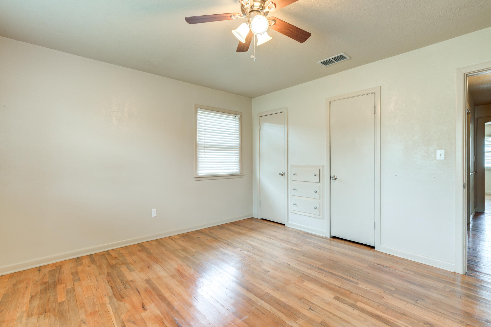 3517 47th Street Lubbock, TX 79413 - Photo 20 of 36 wooden floor in an empty room with a window