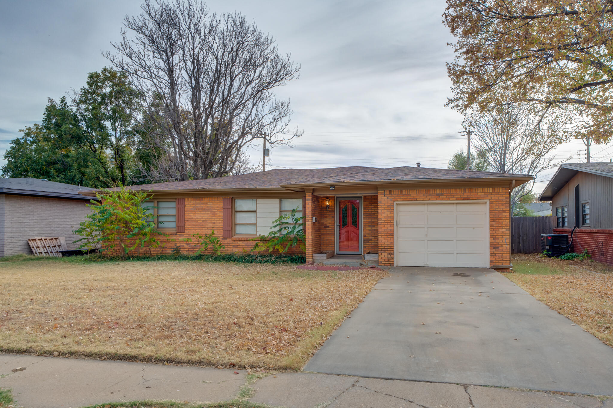 3517 47th Street Lubbock, TX 79413 - Photo 2 of 36 a view of a house with a yard and garage
