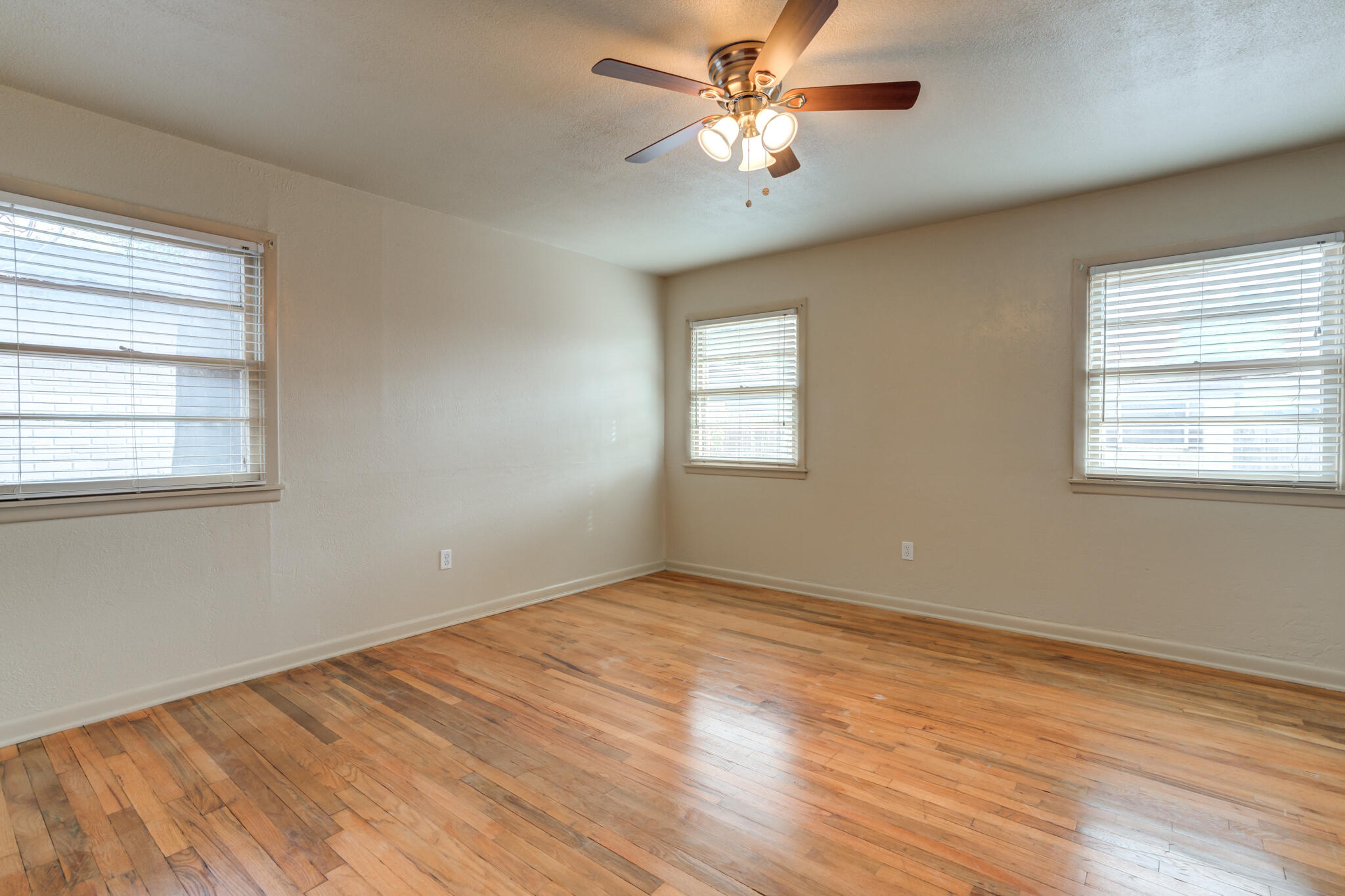 3517 47th Street Lubbock, TX 79413 - Photo 29 of 36 a view of empty room with wooden floor and fan