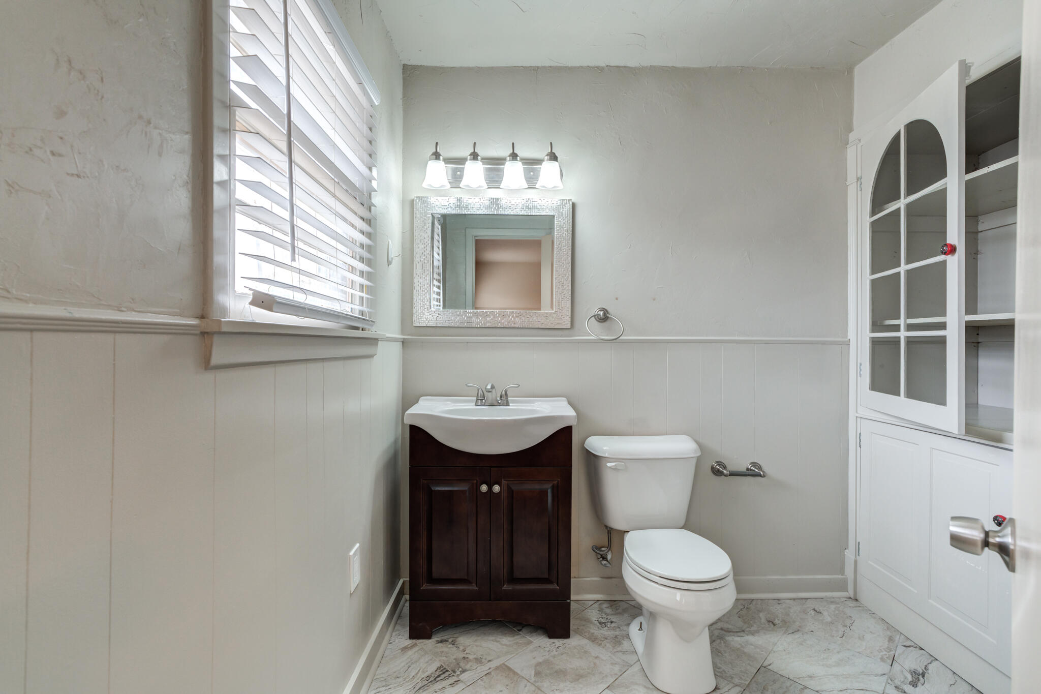 3517 47th Street Lubbock, TX 79413 - Photo 30 of 36 a bathroom with a toilet a sink and mirror