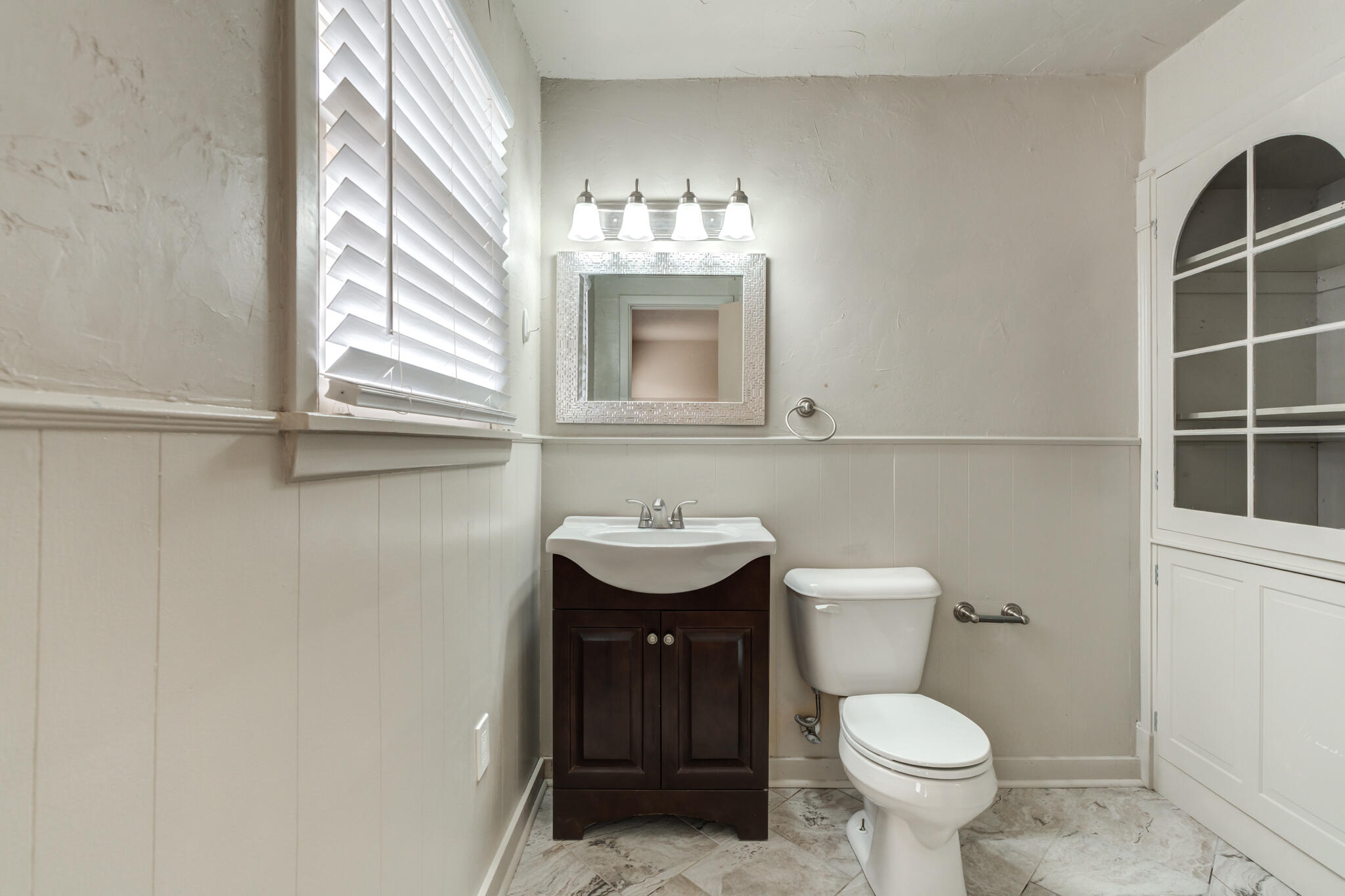3517 47th Street Lubbock, TX 79413 - Photo 31 of 36 a bathroom with a sink and a mirror