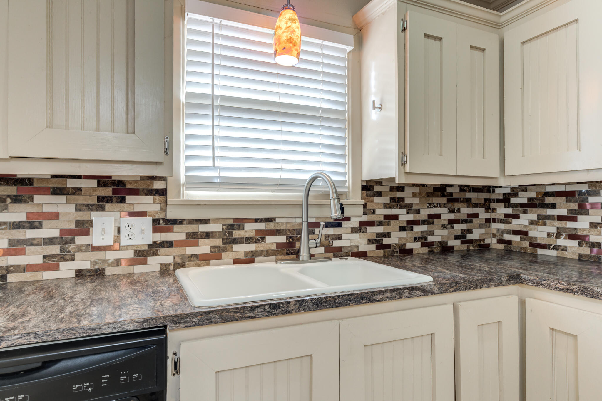 3517 47th Street Lubbock, TX 79413 - Photo 8 of 36 a kitchen with granite countertop a sink and a white wooden cabinets