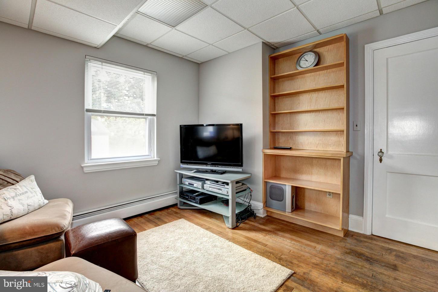 10009 Sutherland Road Silver Spring, MD 20901 - Photo 11 of 27 a living room with furniture and a flat screen tv