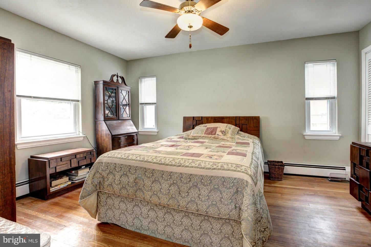10009 Sutherland Road Silver Spring, MD 20901 - Photo 14 of 27 a bedroom with a bed and wooden floor