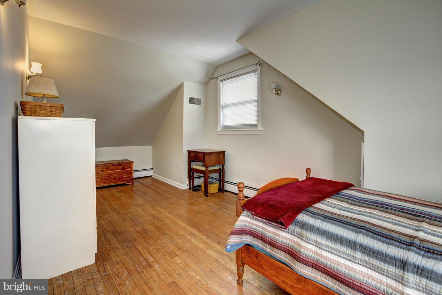 10009 Sutherland Road Silver Spring, MD 20901 - Photo 16 of 27 a bedroom with a bed and a refrigerator