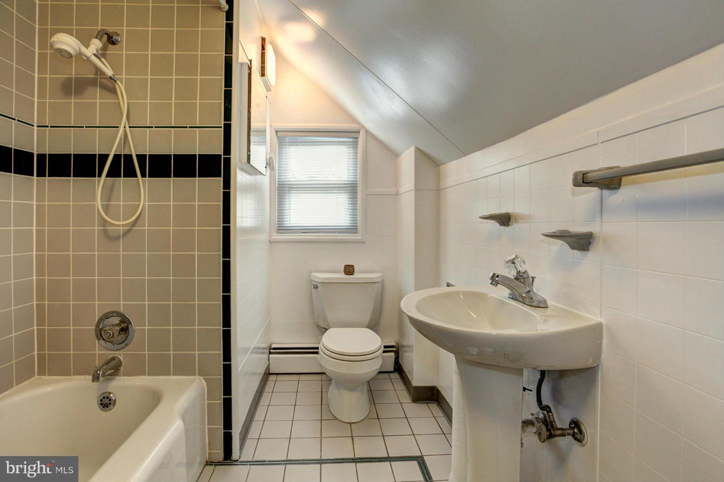 10009 Sutherland Road Silver Spring, MD 20901 - Photo 19 of 27 a bathroom with a sink a toilet and shower