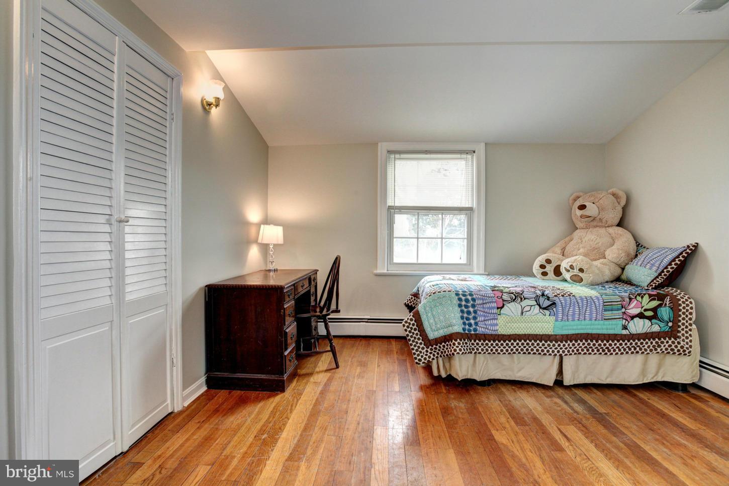 10009 Sutherland Road Silver Spring, MD 20901 - Photo 20 of 27 a bedroom with a bed and wooden floor