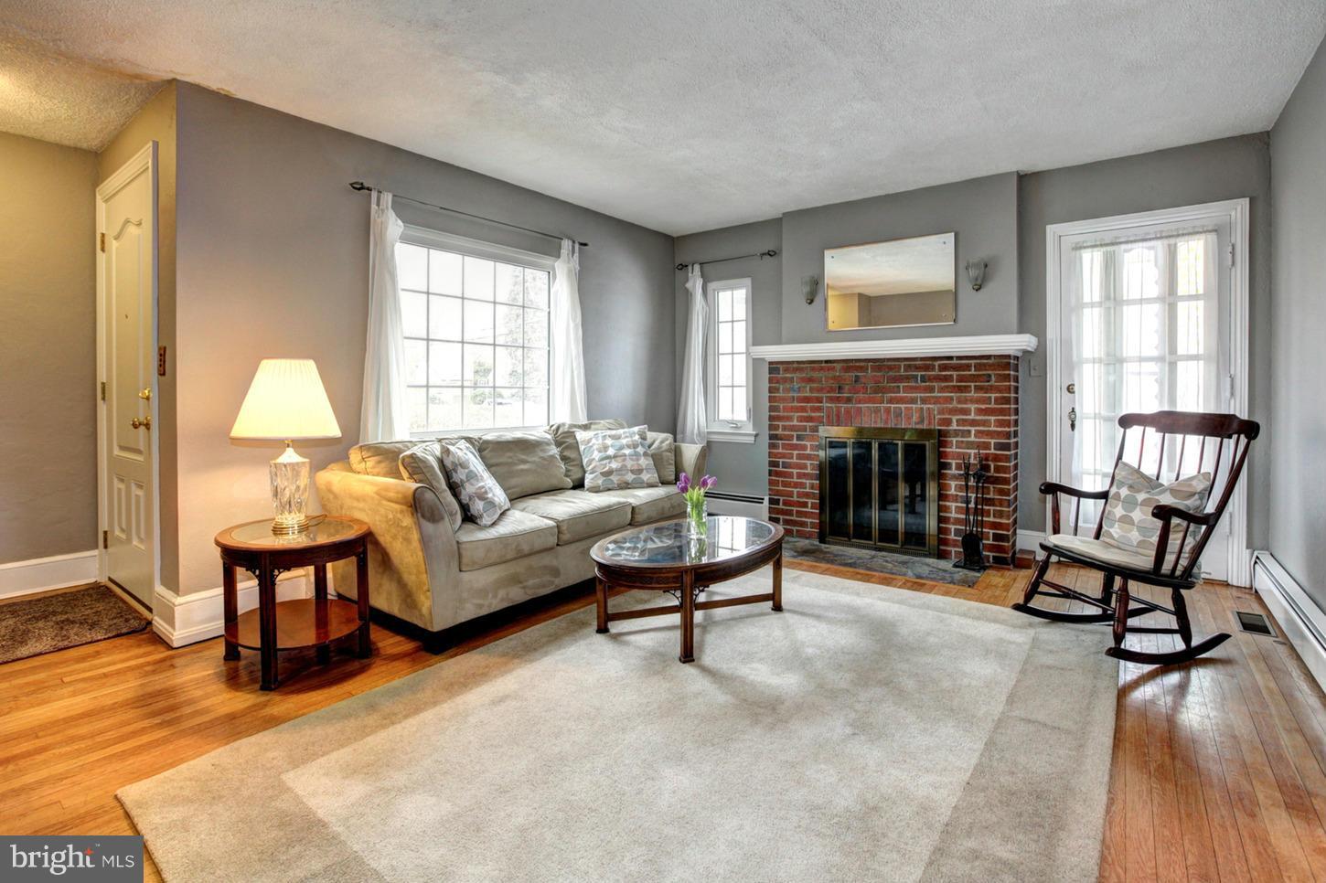 10009 Sutherland Road Silver Spring, MD 20901 - Photo 3 of 27 a living room with furniture and a fireplace