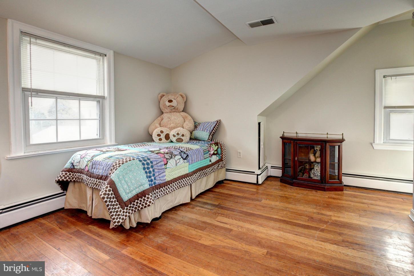 10009 Sutherland Road Silver Spring, MD 20901 - Photo 21 of 27 a bedroom with a bed and a window