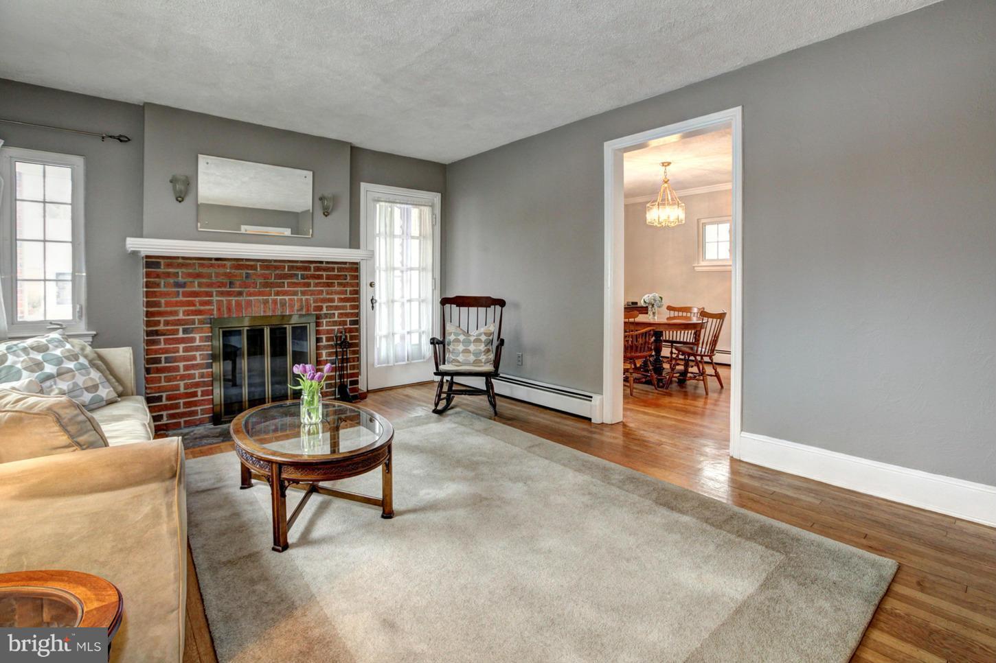 10009 Sutherland Road Silver Spring, MD 20901 - Photo 4 of 27 a living room with furniture and a fireplace