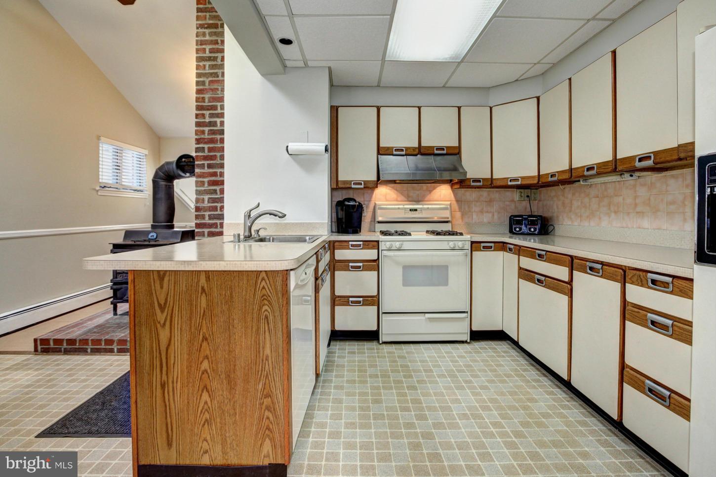 10009 Sutherland Road Silver Spring, MD 20901 - Photo 7 of 27 a kitchen with a stove sink and cabinets