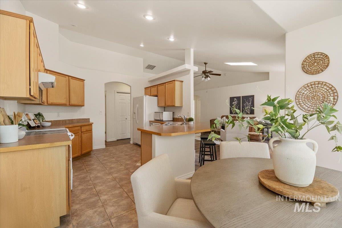 2032 Talus Loop Twin Falls, ID 83301 - Photo 21 of 43 Kitchen featuring wood cabinetry, tile flooring, recessed lighting, and a skylight