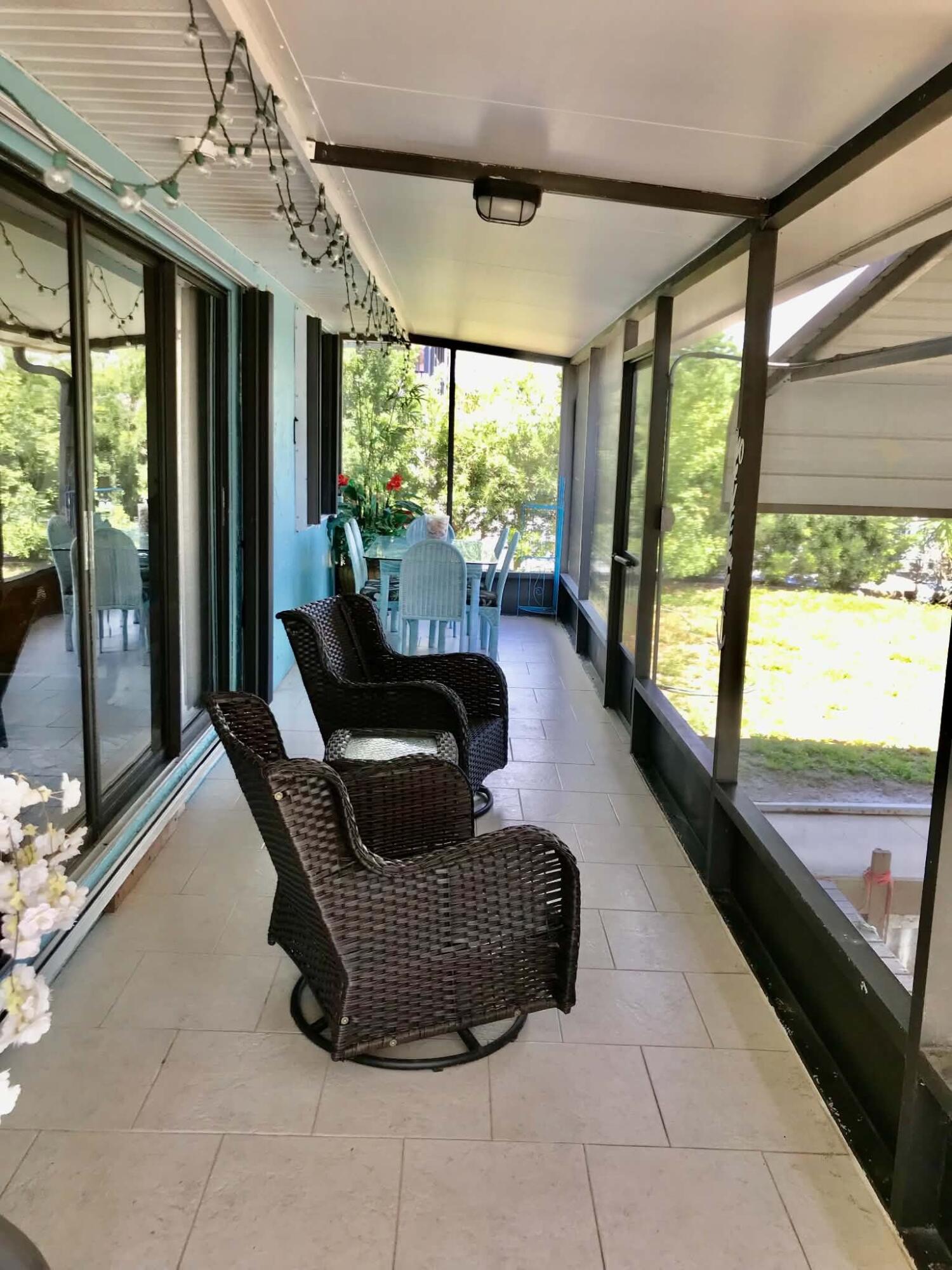 1115 Elm Street Okeechobee, FL 34974 - Photo 24 of 37 a living room with furniture and a floor to ceiling window
