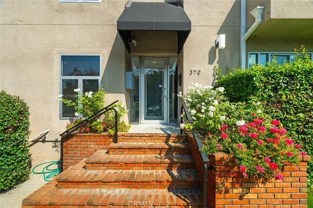 a view of a house with potted plants