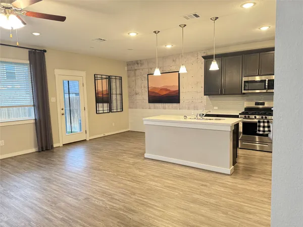 a view of kitchen with stainless steel appliances a stove top oven