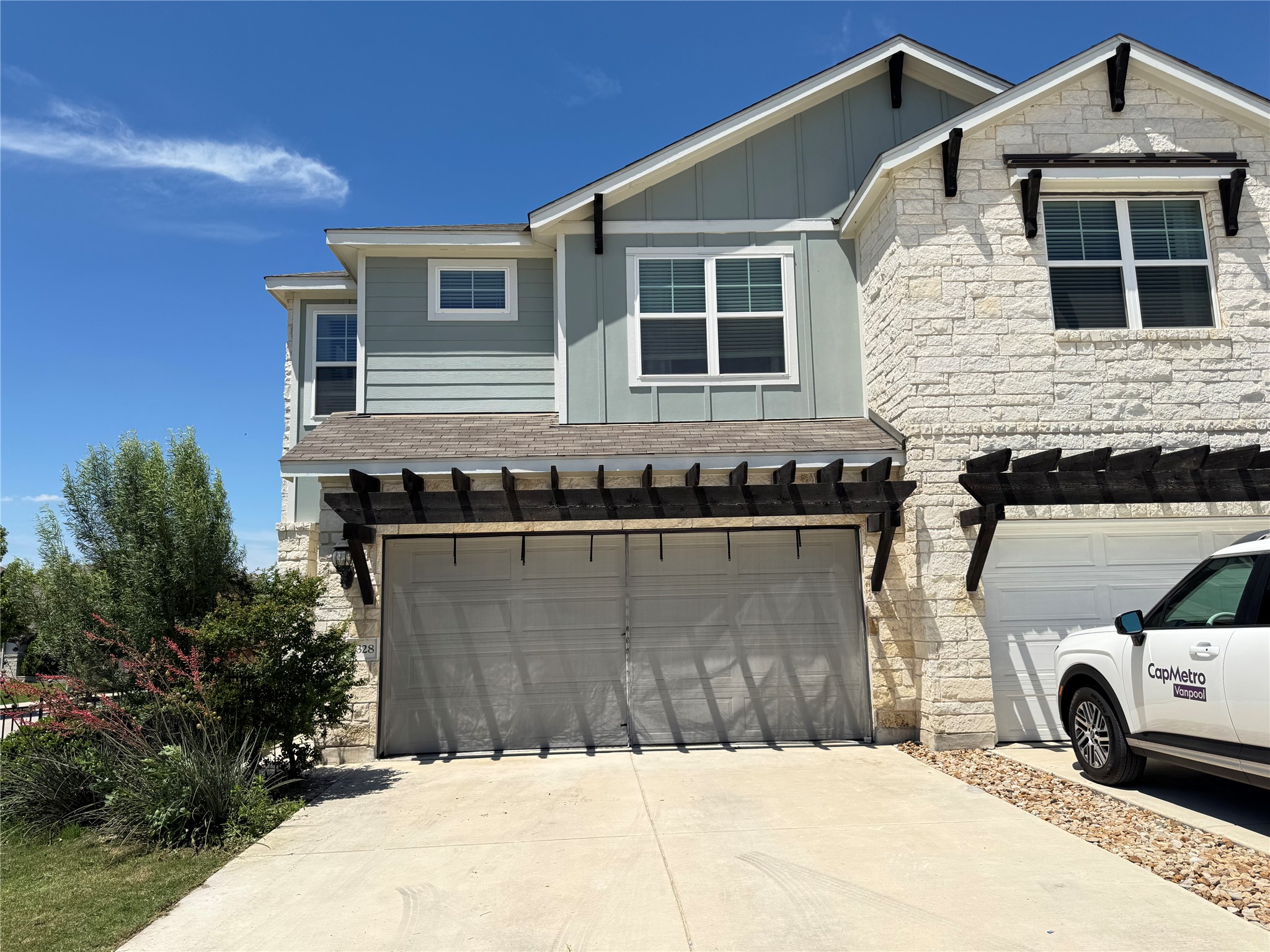 Contemporary exterior featuring light-colored stone and horizontal siding