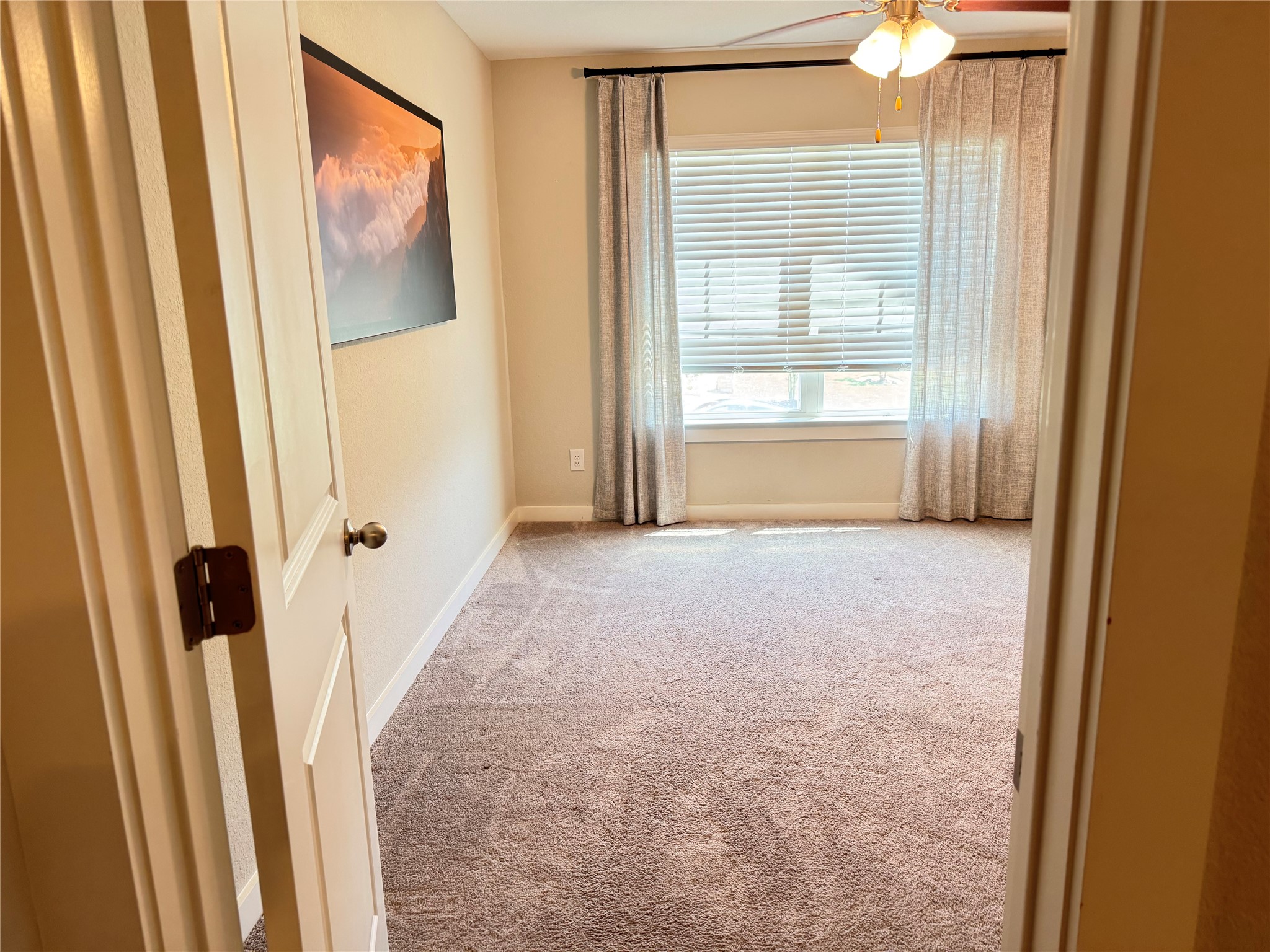 2328 Calvert Drive Leander, TX 78641 - Photo 10 of 35 Carpeted room featuring a ceiling fan with light fixture, a window with blinds, and neutral-toned walls
