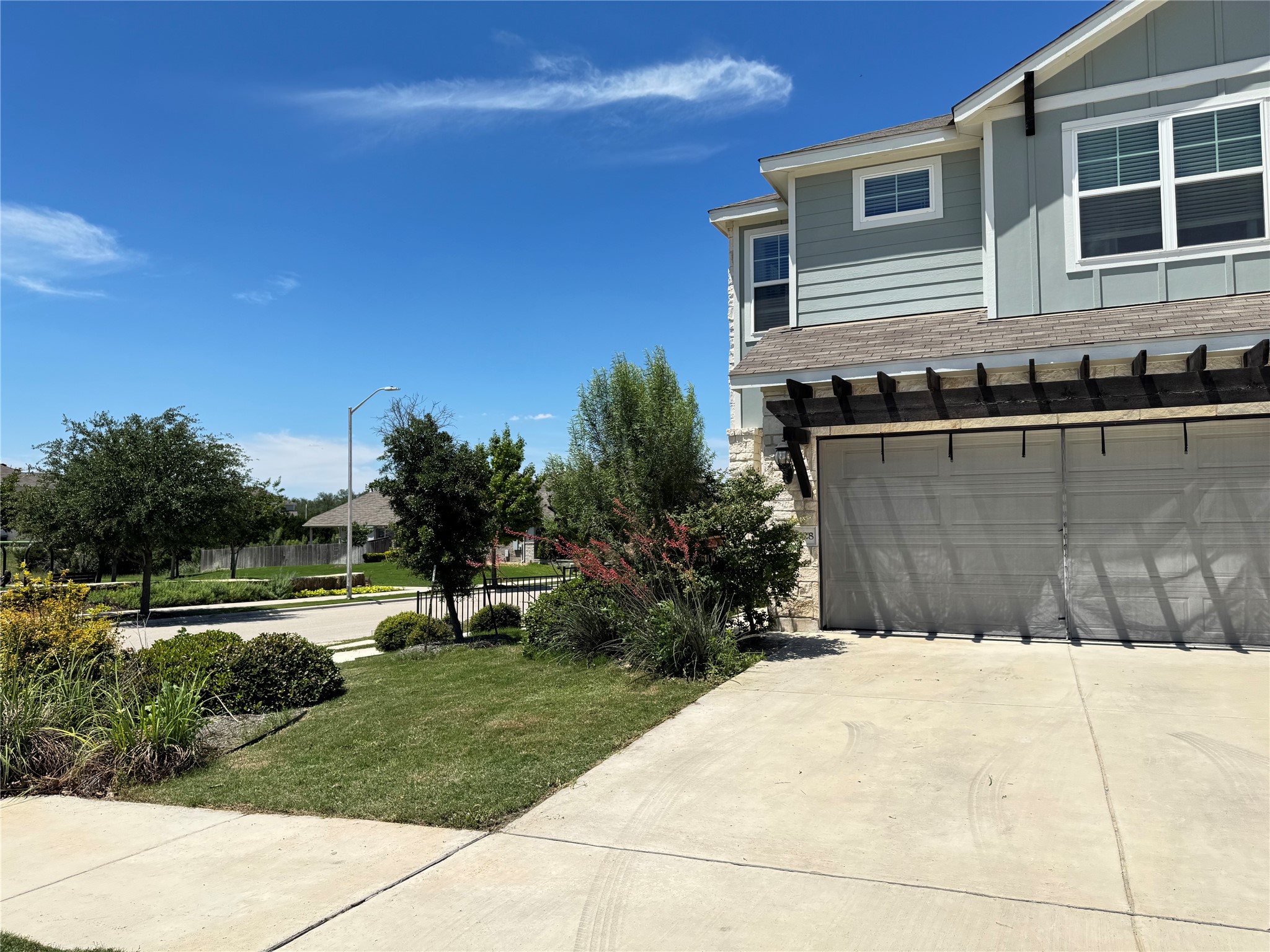 2328 Calvert Drive Leander, TX 78641 - Photo 2 of 35 Light blue siding exterior with stone accents and a two-car garage