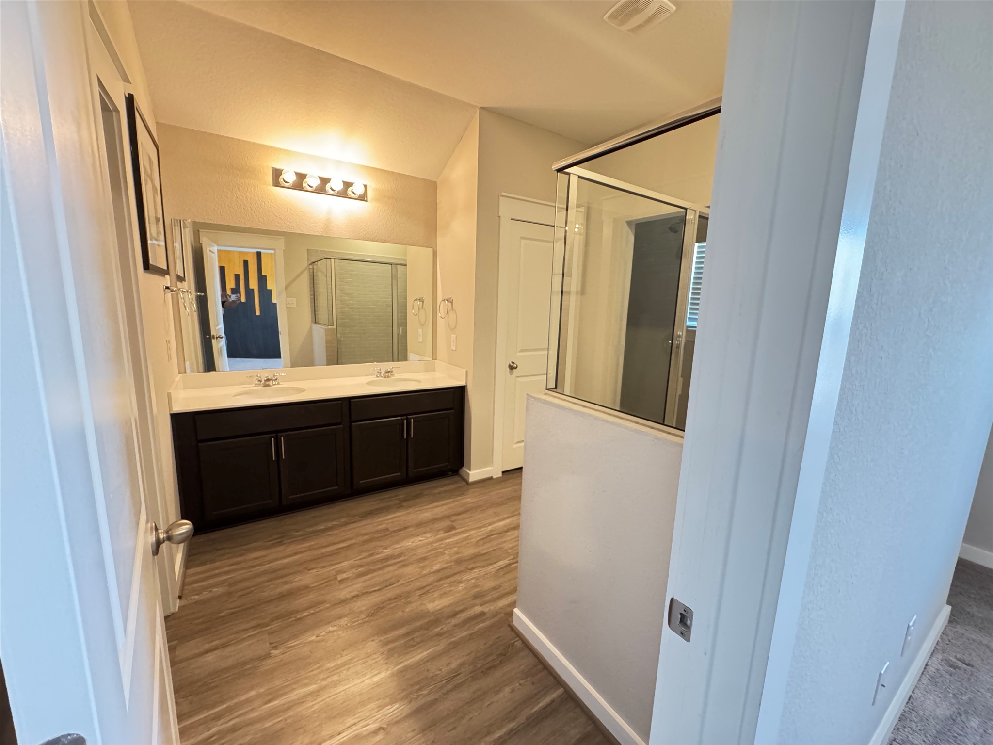2328 Calvert Drive Leander, TX 78641 - Photo 22 of 35 Bathroom featuring a double vanity with dark cabinetry, white countertops, and dual undermount sinks