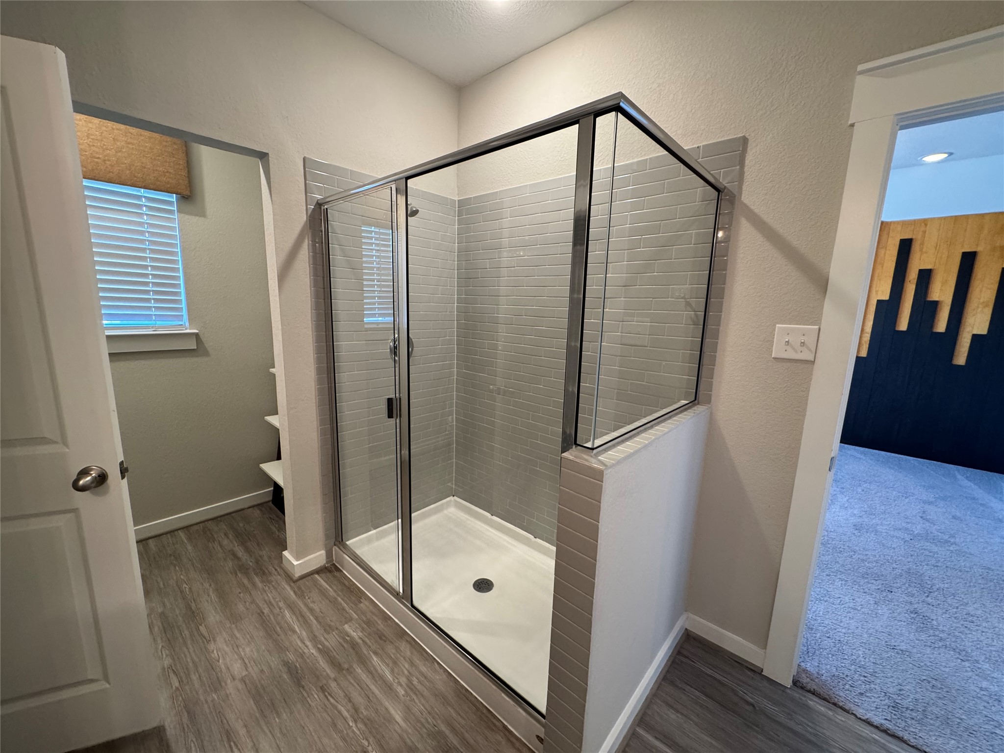 2328 Calvert Drive Leander, TX 78641 - Photo 26 of 35 Walk-in shower with clear glass enclosure and subway tile surround