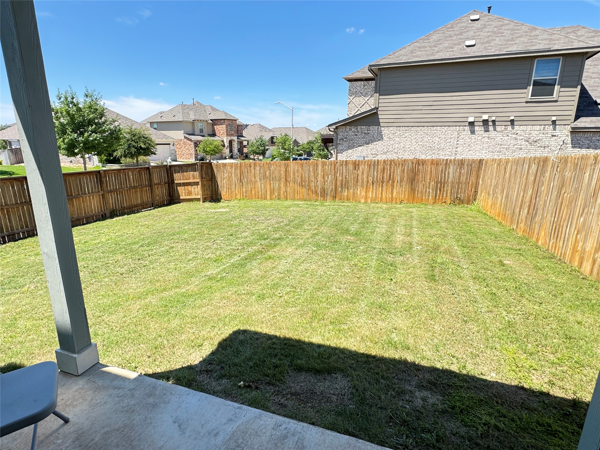 2328 Calvert Drive Leander, TX 78641 - Photo 29 of 35 Expansive backyard featuring a manicured lawn, full wood privacy fencing, and a concrete patio space