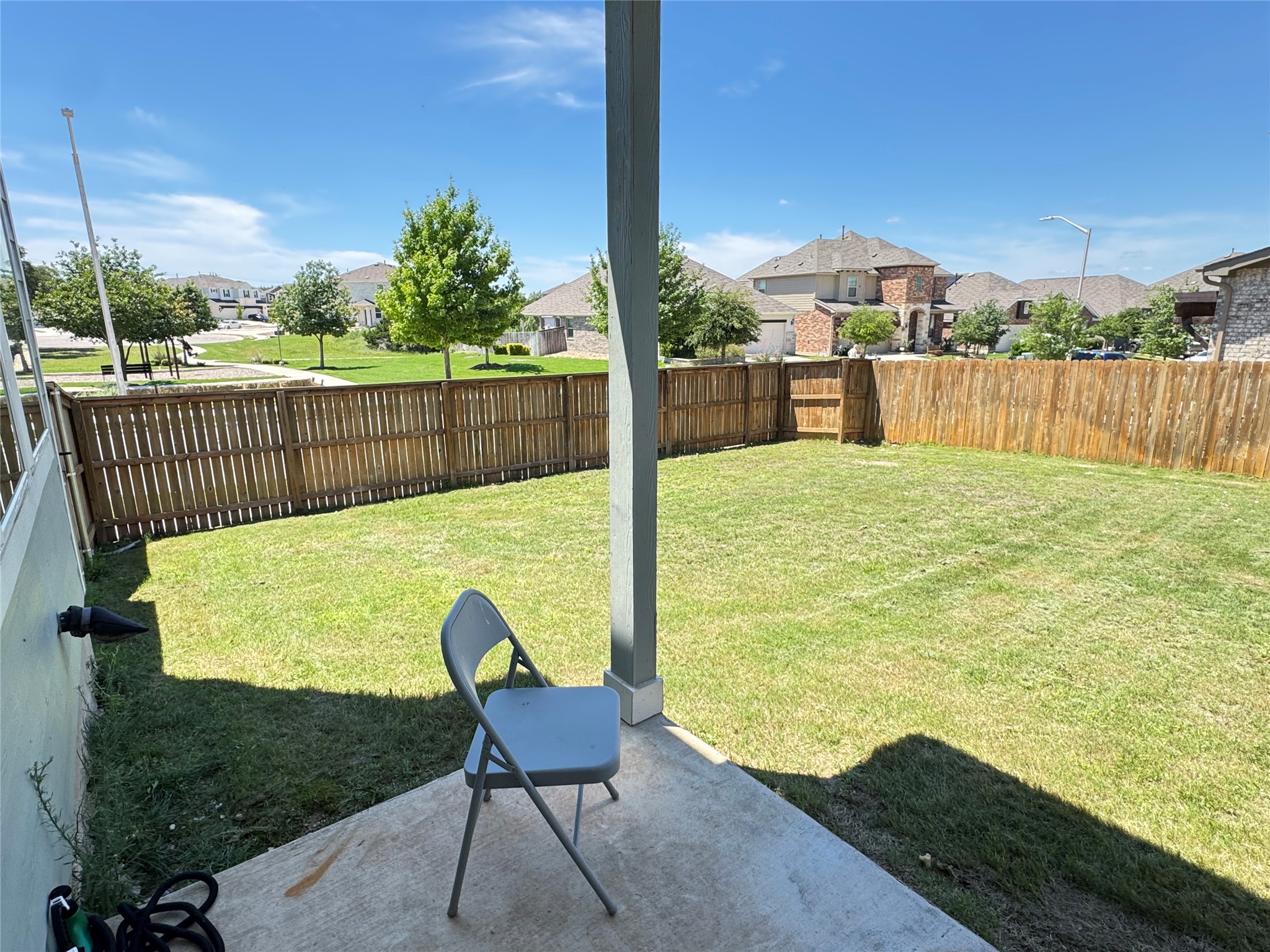 2328 Calvert Drive Leander, TX 78641 - Photo 31 of 35 Expansive backyard featuring a manicured lawn, full wood fencing, and a concrete patio