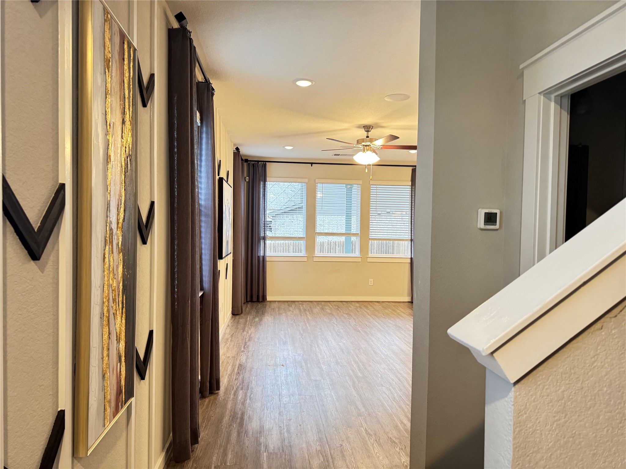 2328 Calvert Drive Leander, TX 78641 - Photo 2 of 17 a view of a hallway with wooden floor and staircase