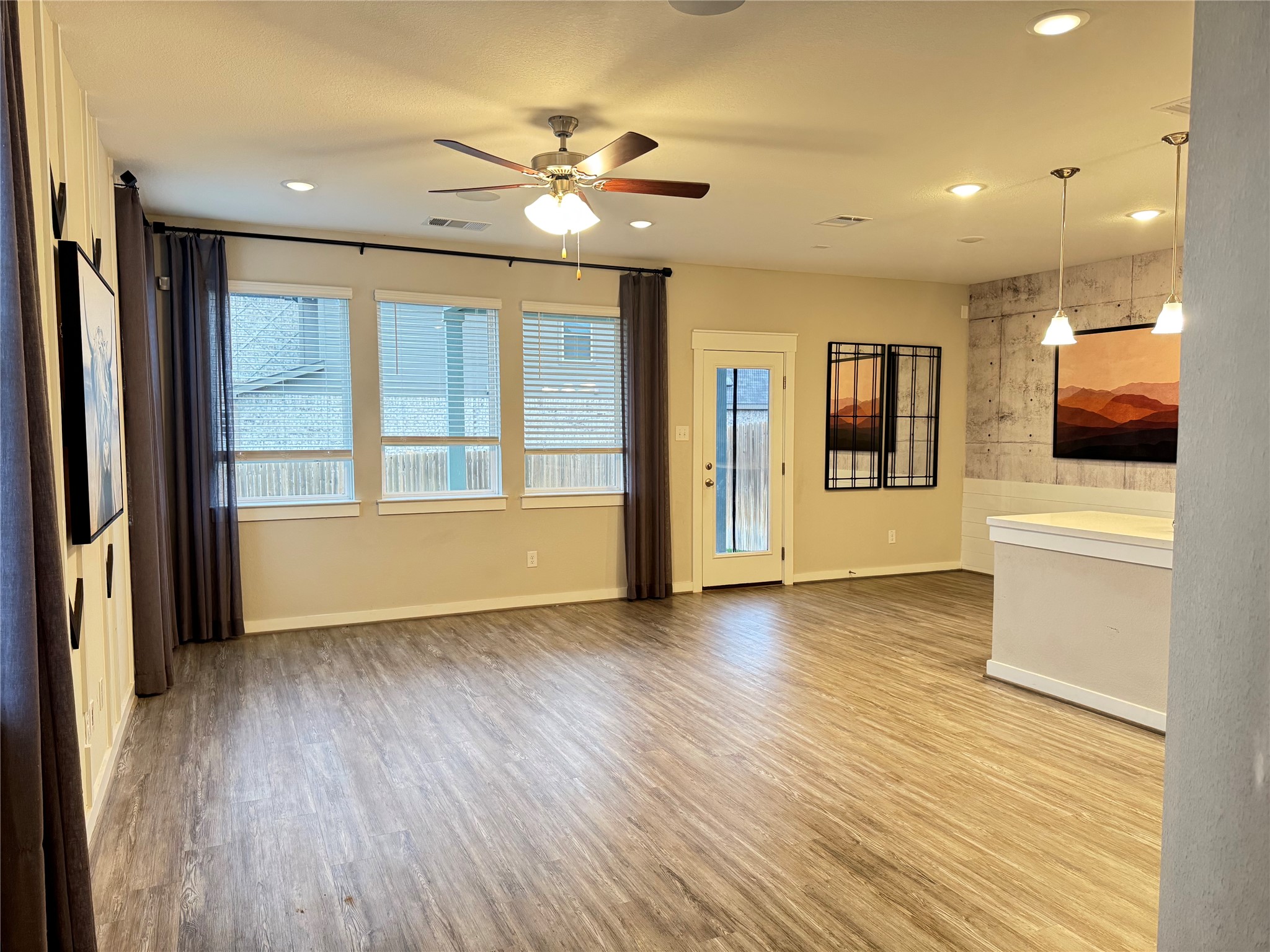 2328 Calvert Drive Leander, TX 78641 - Photo 3 of 17 an empty room with wooden floor and windows