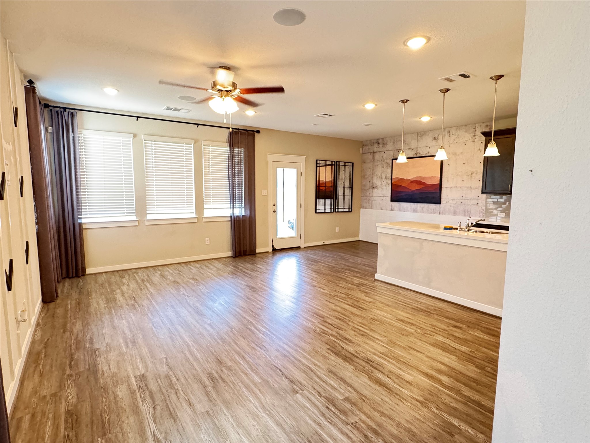 2328 Calvert Drive Leander, TX 78641 - Photo 5 of 35 Open-concept living area featuring wood-finish flooring, recessed lighting, and a ceiling fan