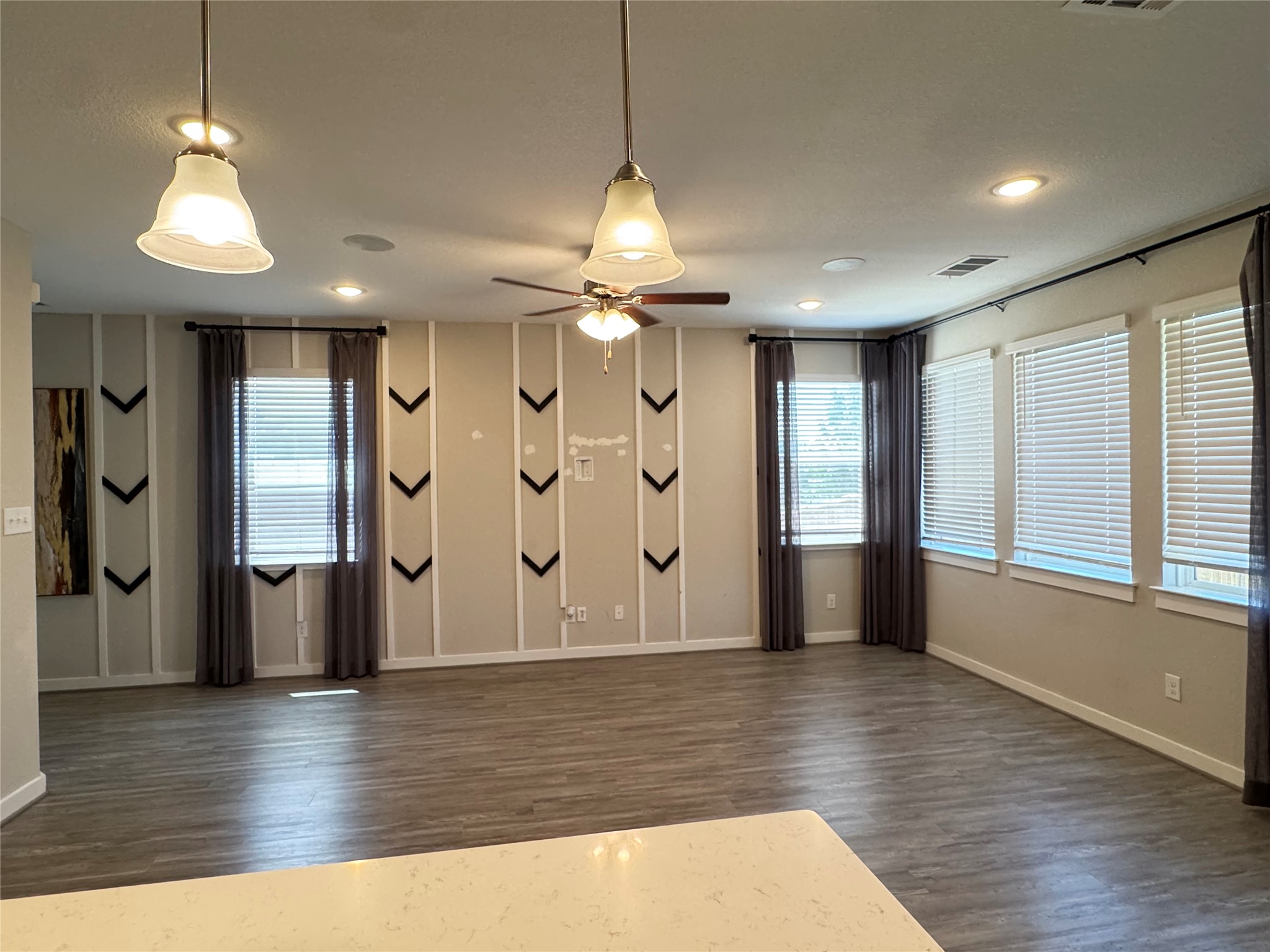 2328 Calvert Drive Leander, TX 78641 - Photo 6 of 35 Spacious interior room featuring wood-finish flooring, recessed lighting, and multiple windows with blinds and curtain rods