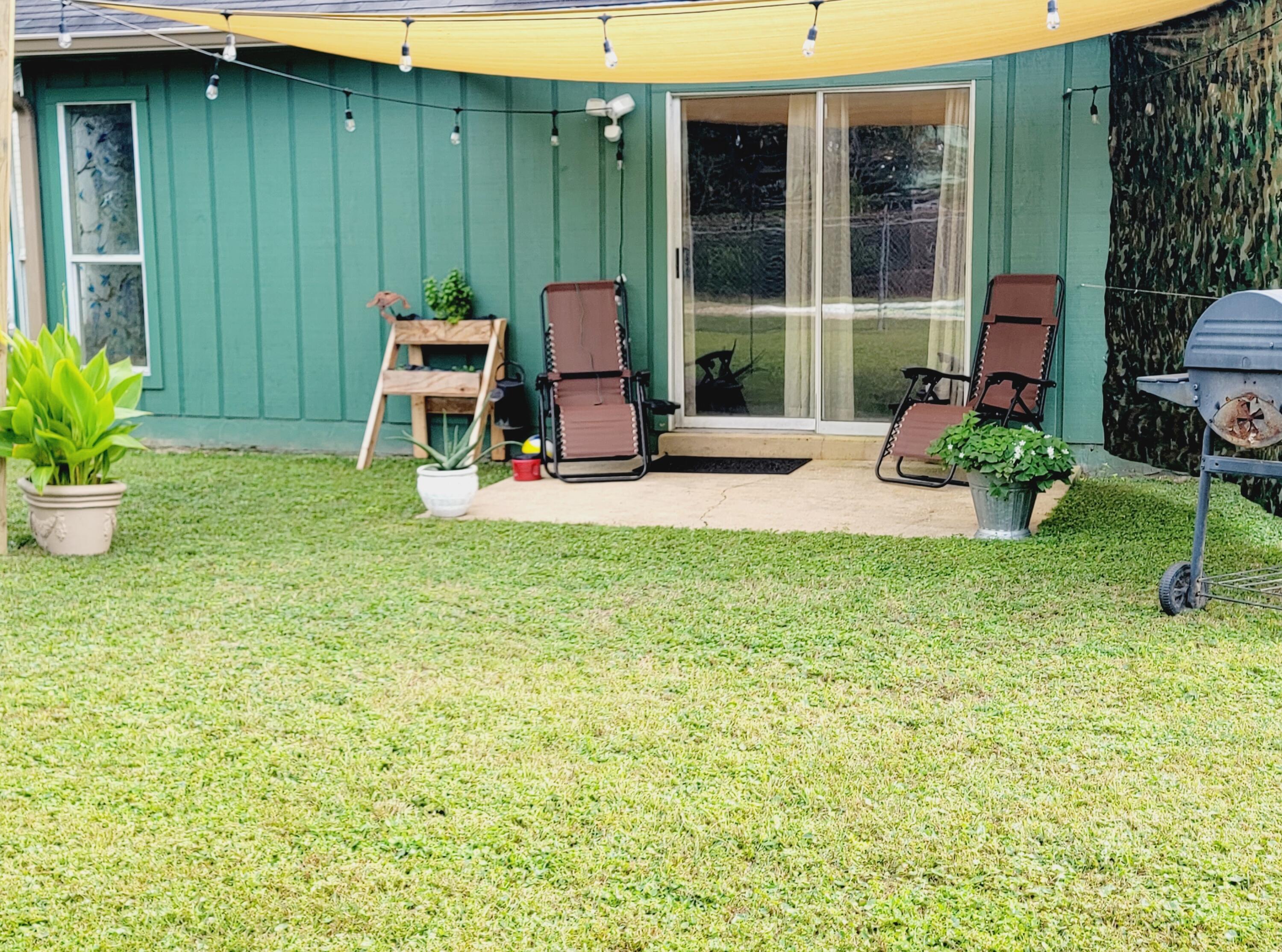 2830 Old Mill Way Crestview, FL 32539 - Photo 13 of 16 a view of a backyard with table and chairs and potted plants