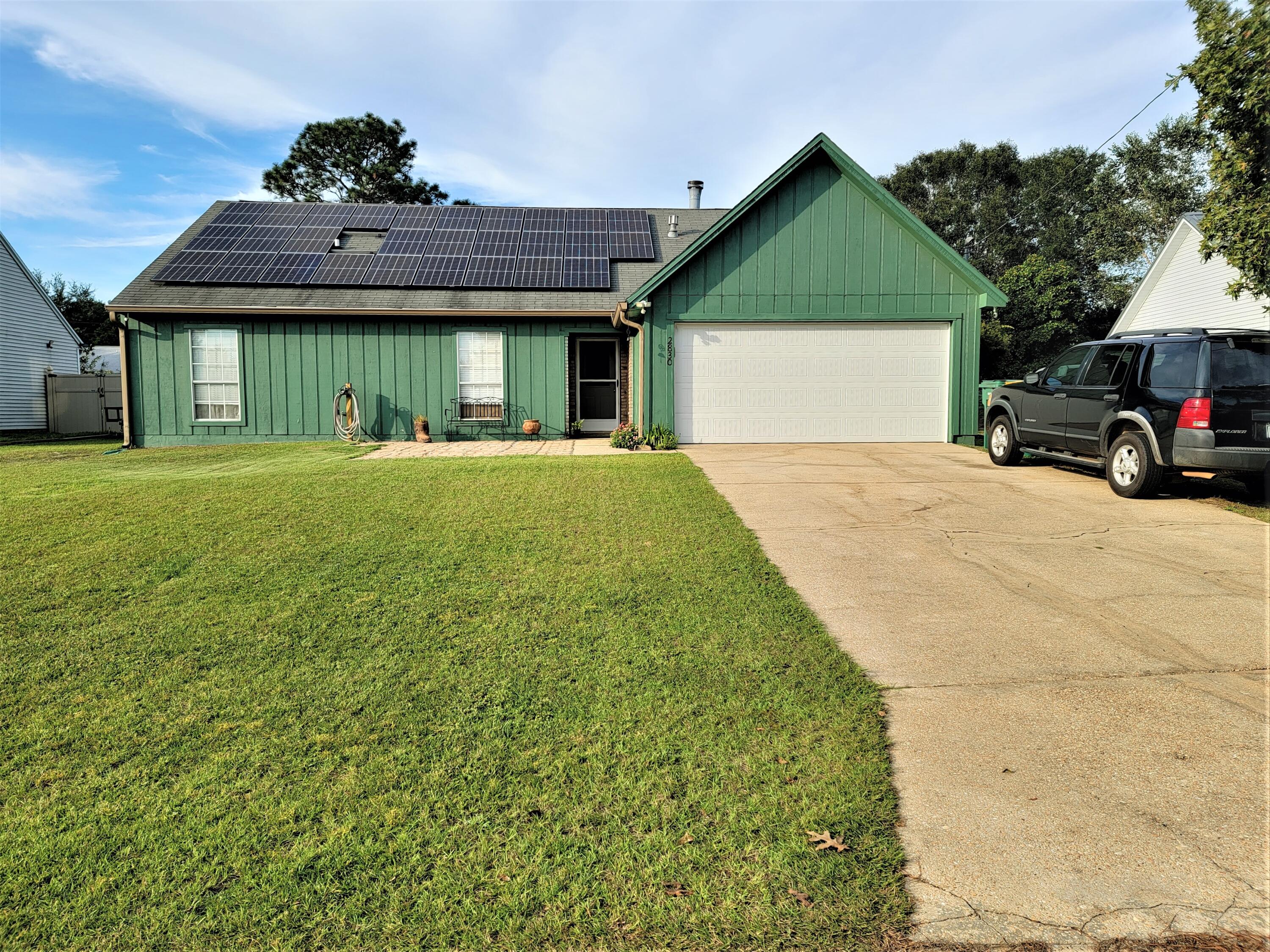2830 Old Mill Way Crestview, FL 32539 - Photo 15 of 16 a front view of a house with garden