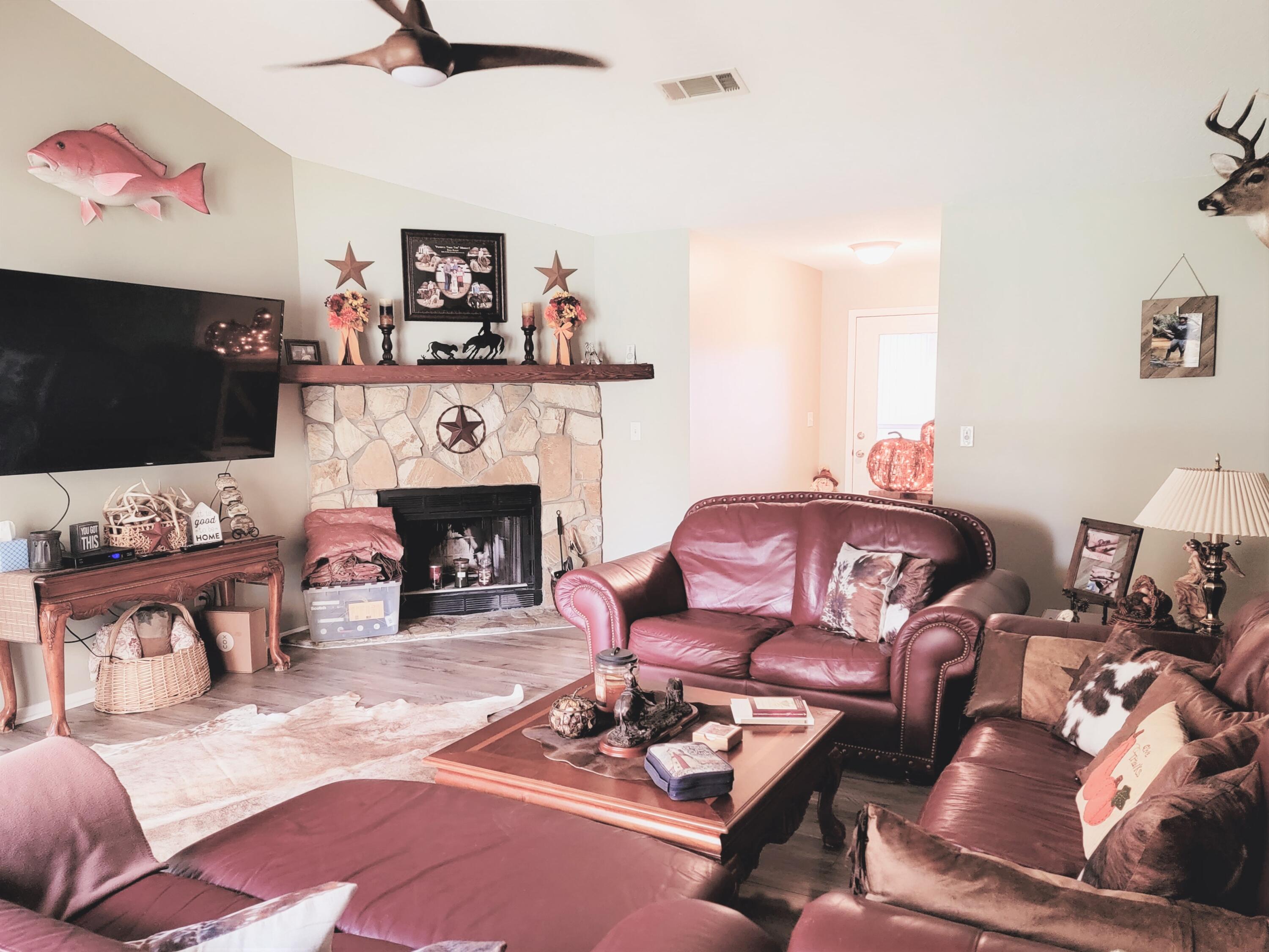 2830 Old Mill Way Crestview, FL 32539 - Photo 4 of 16 a living room with furniture a flat screen tv and a fireplace
