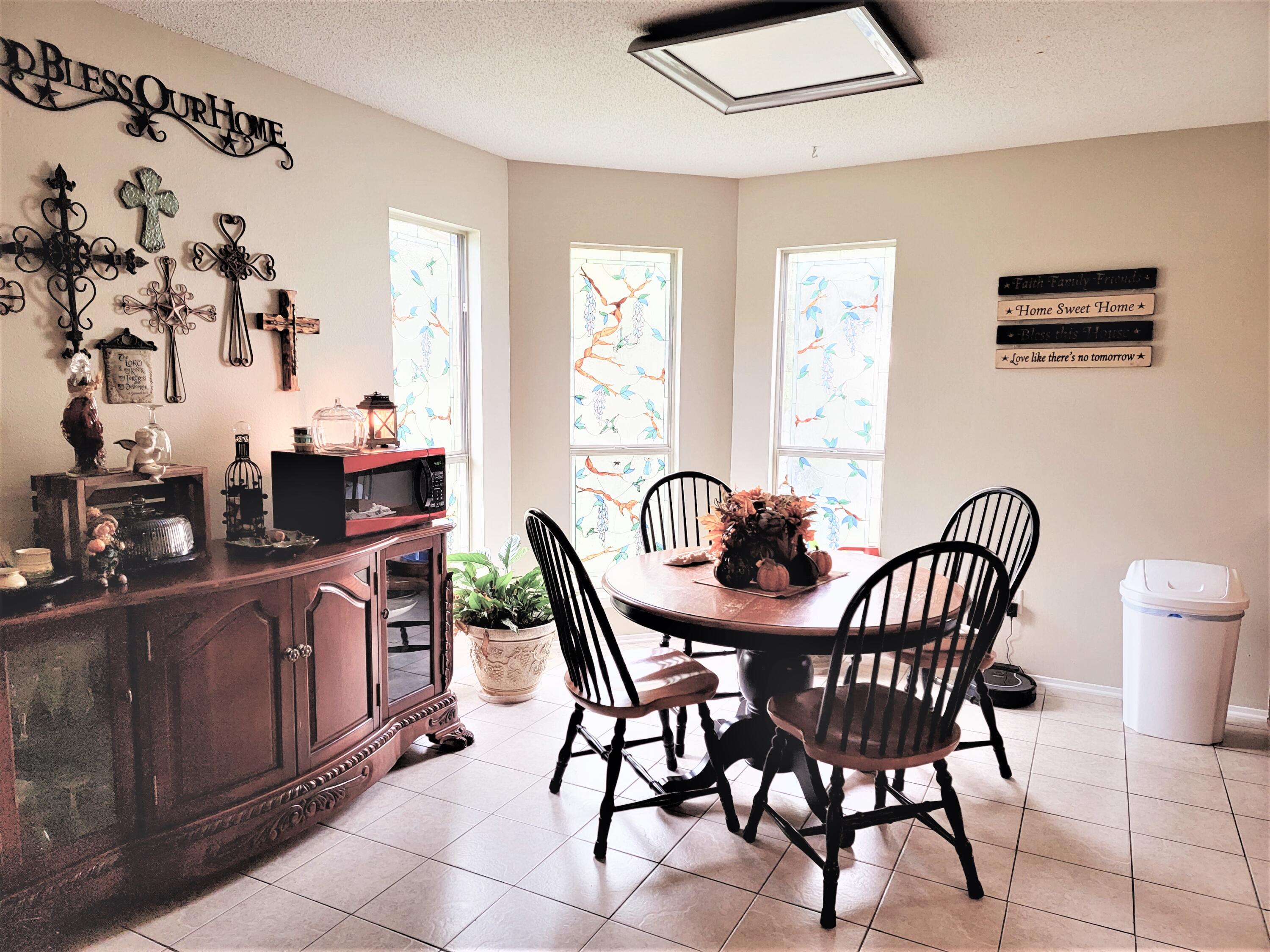 2830 Old Mill Way Crestview, FL 32539 - Photo 6 of 16 a view of a dining room and kitchen with furniture window and wooden floor