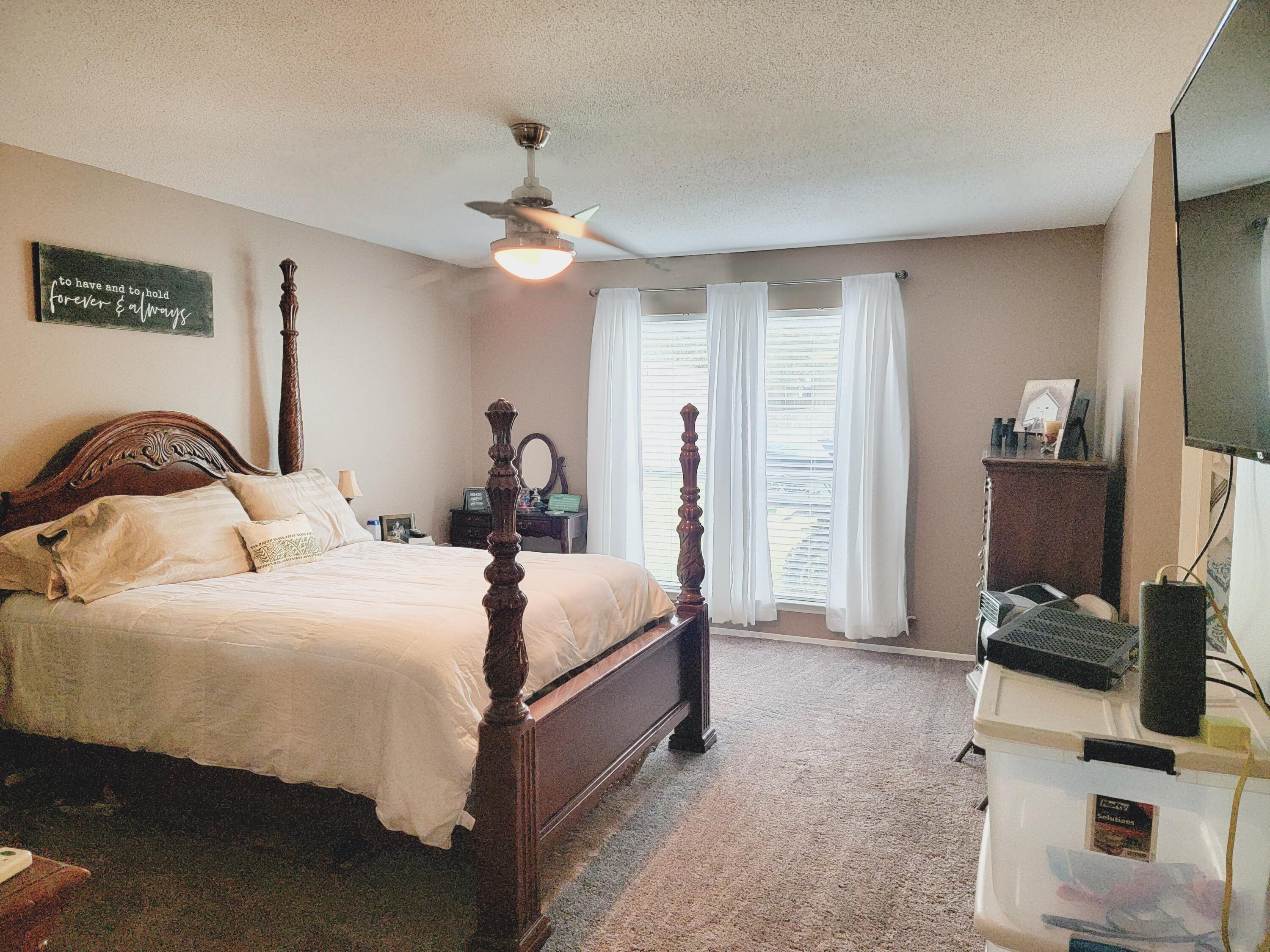 2830 Old Mill Way Crestview, FL 32539 - Photo 7 of 16 a bedroom with a bed and a flat screen tv