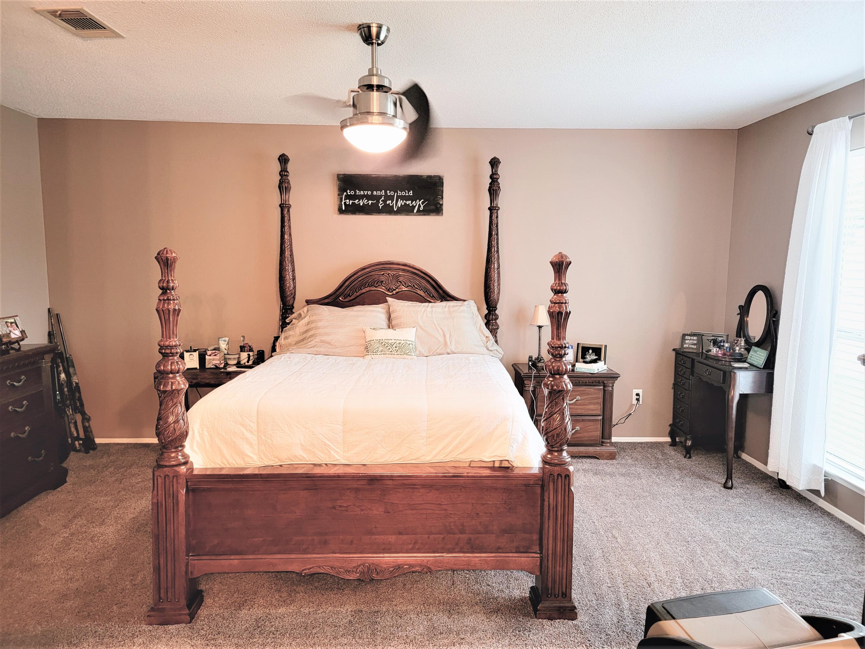2830 Old Mill Way Crestview, FL 32539 - Photo 8 of 16 a bedroom with a bed and a lamp on the dresser