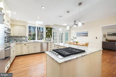 a kitchen with stainless steel appliances granite countertop a stove and a sink