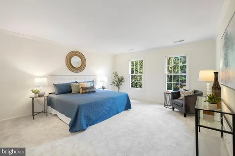 a bedroom with a bed and a potted plant