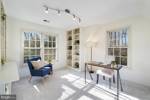 a living room with furniture a rug and a window