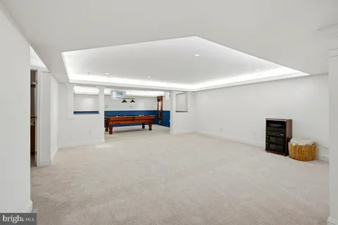 a room with pool table and windows