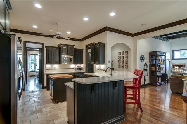 1334 Eliot Road Franklin, TN 37064 - Photo 5 of 20 Spacious kitchen features travertine floors, Zodiaq solid surface quartz counters, subway tile backsplash, distressed black cabinetry and stainless steel double ovens and appliances