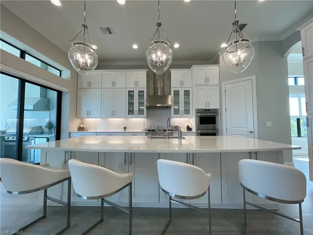 a large kitchen with a table and chairs