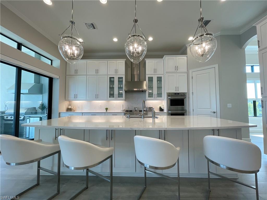 9412 Rapallo Street Naples, FL 34119 - Photo 15 of 34 a large kitchen with a table and chairs